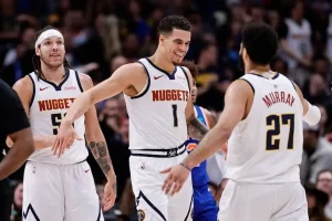 Denver Nuggets players celebrate on the court.