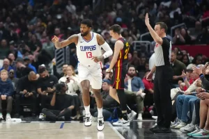 Los Angeles Clippers player Paul George reacts after a play near the sideline.