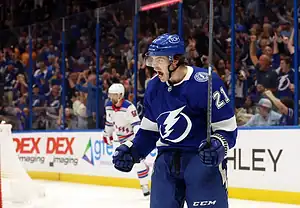 Tampa Bay Lightning player celebrating on the ice during a game against the New York Rangers.