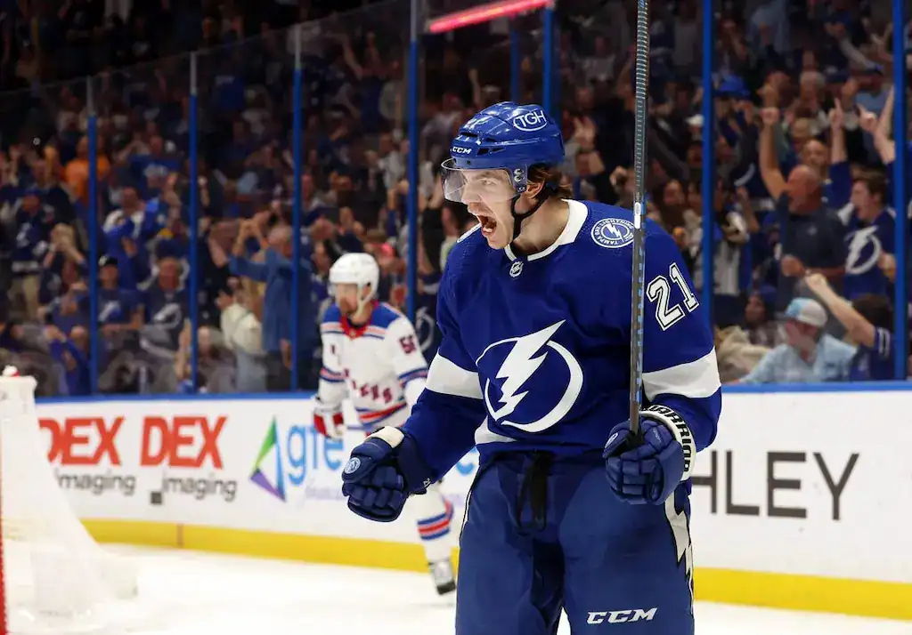 Tampa Bay Lightning player celebrating on the ice during a game against the New York Rangers.