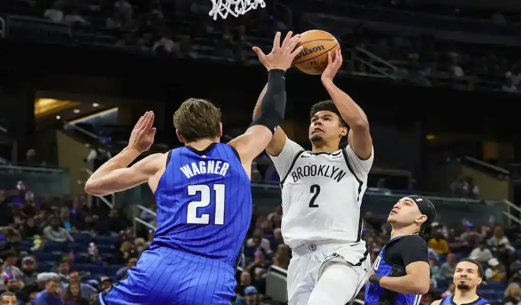 Brooklyn Nets player drives to the basket while being defended by Orlando Magic's Franz Wagner during a March 2, 2024, game.