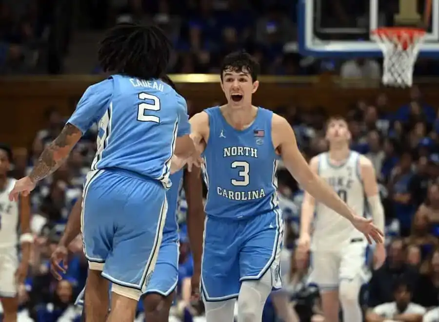 NCAAB 2 North Carolina basketball players celebrating on the court