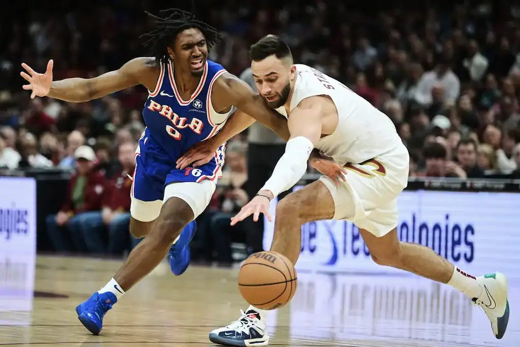 9 A tense moment in a basketball game, with two players competing for the ball, showcasing dynamic movement on the court.