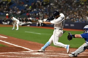 Tampa Bay Rays batter Brandon Lowe makes contact with the ball during a game.
