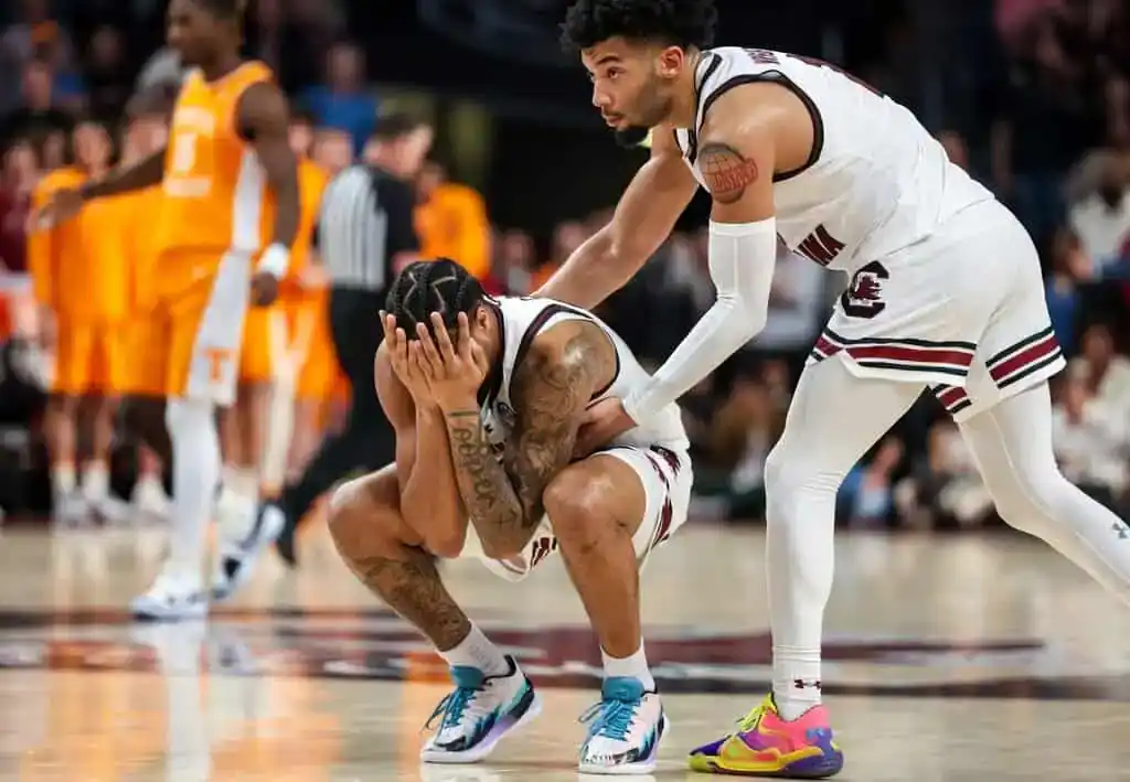 NCAAB 8 College basketball player in a white uniforM
