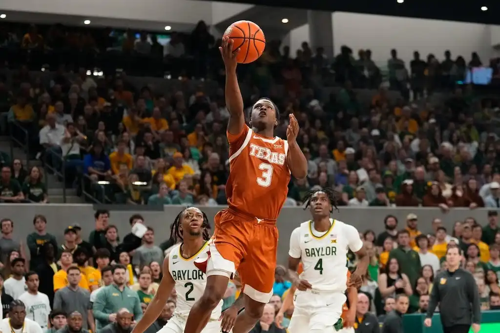 NCAAB 4 A Texas basketball player goes up for a layup.