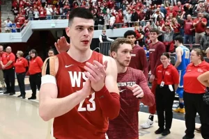 basketball player clapping while bleeding from his mouth