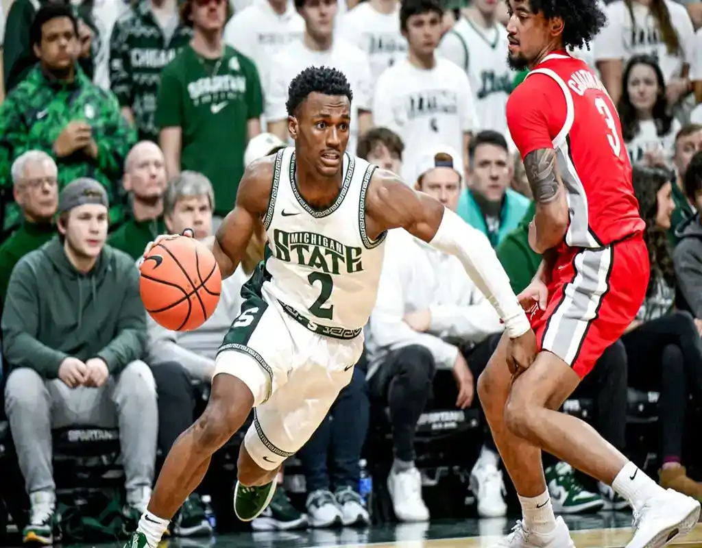 Michigan State Spartans player drives past Northwestern Wildcats defender during their March 6, 2024 matchup