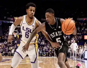 Mississippi State Bulldogs #5 driving past Louisiana State Tigers defender #6 during a college basketball game