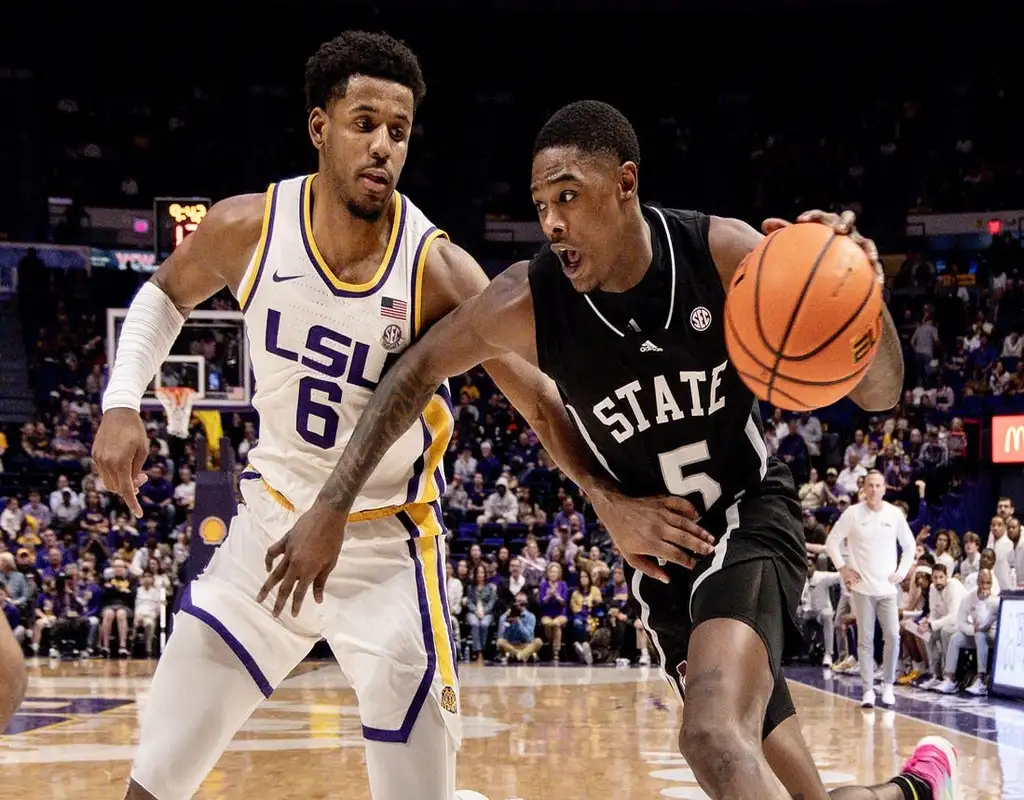 NCAAB 4 Mississippi State Bulldogs #5 driving past Louisiana State Tigers defender #6 during a college basketball game