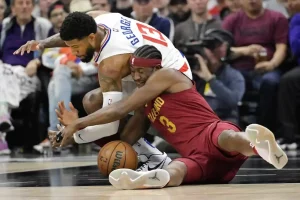Cleveland Cavaliers player dives on the floor to battle for a loose ball against a Los Angeles Clippers player