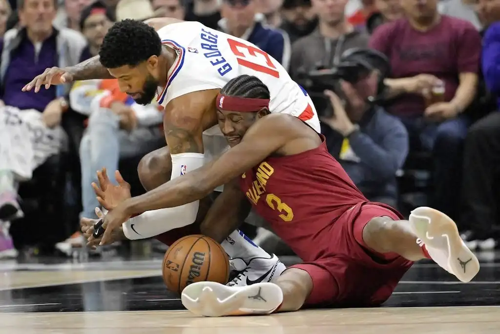 Cleveland Cavaliers player dives on the floor to battle for a loose ball against a Los Angeles Clippers player