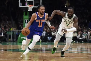 A New York Knicks player drives to the basket.