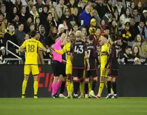 Referee shows red card during heated moment in D.C. United vs Orlando City SC MLS game on April 13, 2024