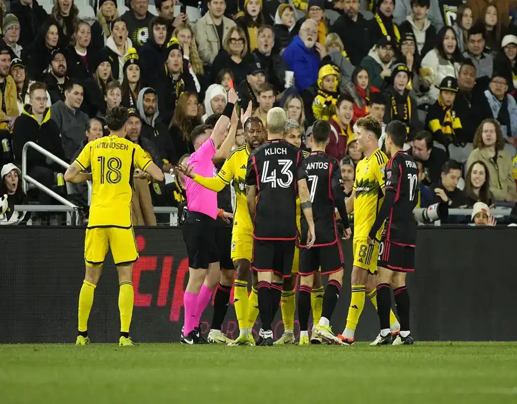Referee shows red card during heated moment in D.C. United vs Orlando City SC MLS game on April 13, 2024