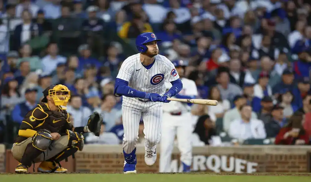 3 Chicago Cubs batter follows through on a hit against the San Diego Padres as catcher readies for play