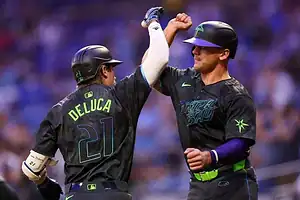 Tampa Bay Rays players celebrate with high-five.