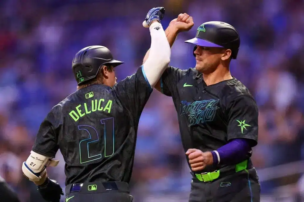 2 Tampa Bay Rays players celebrate with high-five.