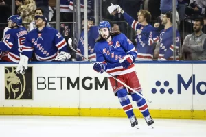 new york rangers nhl player sliding on the field