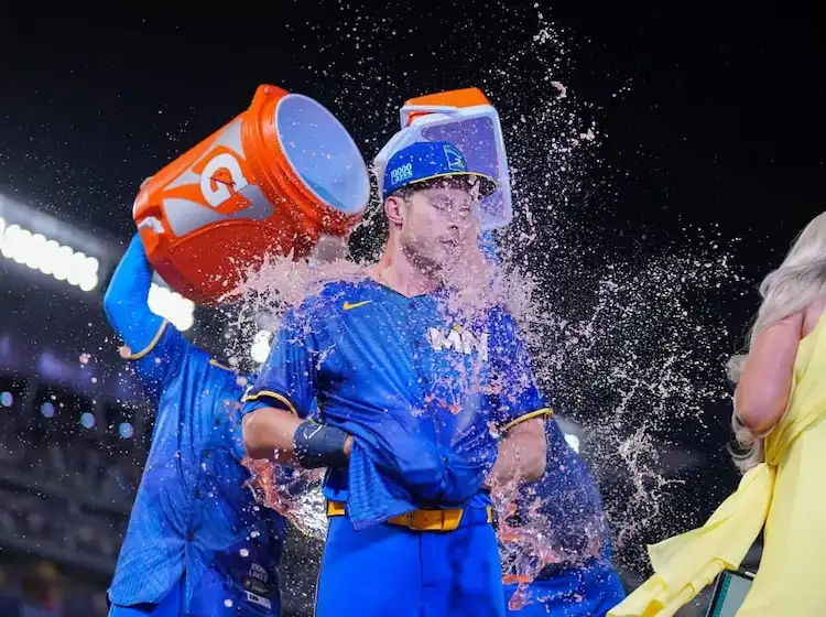 5 A Minnesota Twins player gets drenched with pink sports drink from coolers in a celebratory.
