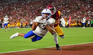 Washington State Cougars wide receiver makes a diving touchdown catch against San Jose State Spartans defender during a college football game.