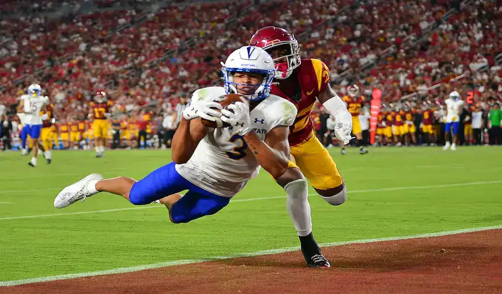 Washington State Cougars wide receiver makes a diving touchdown catch against San Jose State Spartans defender during a college football game.