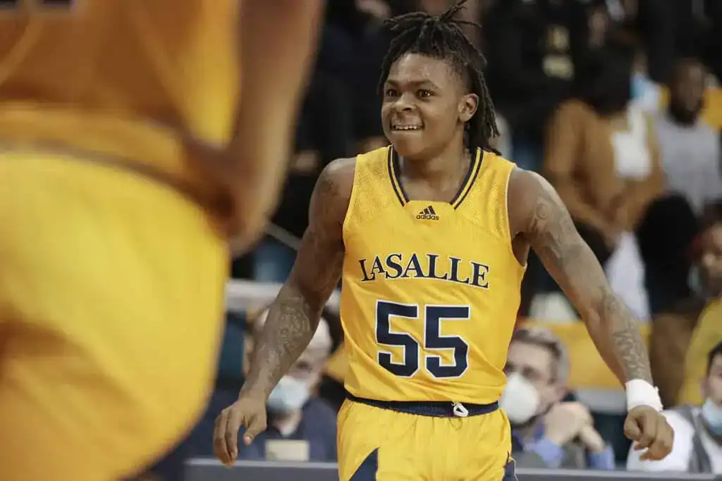 La Salle player in a gold uniform smiling during gameplay, showing energy and intensity.