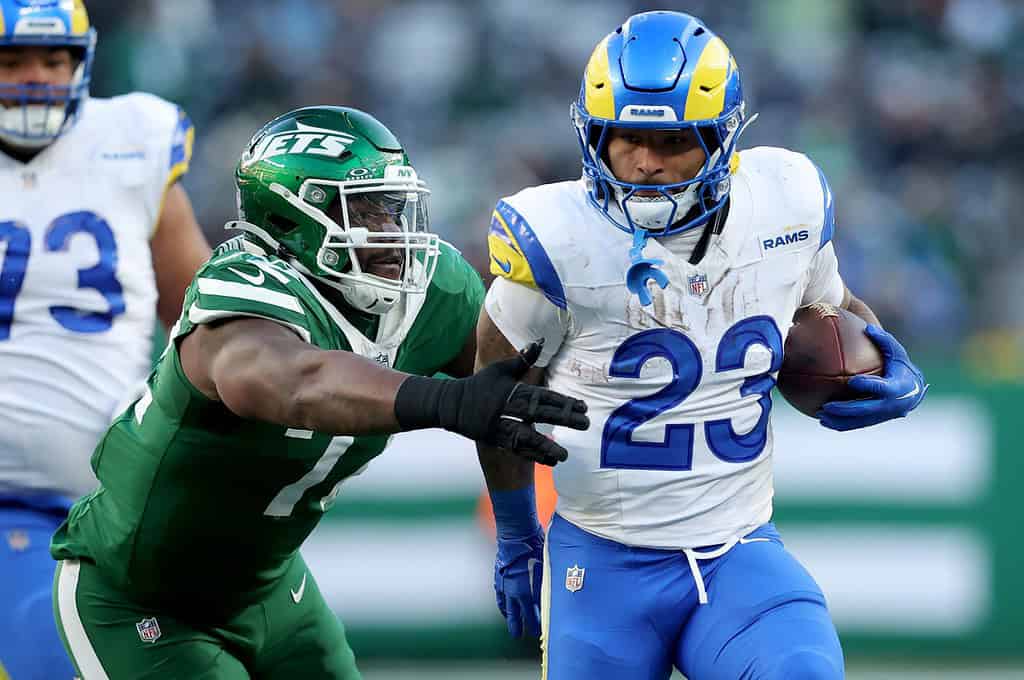 Rams player rushing the ball