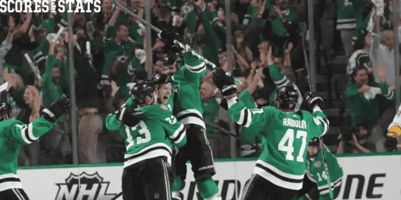 Dallas Stars vs Buffalo Sabres Picks and Predictions December 31st 2024 2 Dallas Stars players in green jerseys celebrate a big win with fans cheering in the background during an NHL game.
