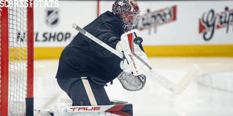 Columbus Blue Jackets vs Carolina Hurricanes Picks and Predictions December 31st 2024 3 Hockey goalie in black gear and colorful mask making a glove save during practice