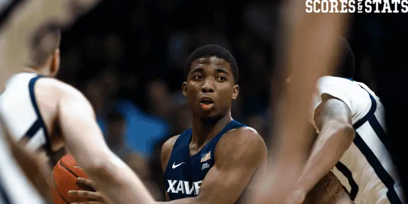 Xavier Musketeers vs Seton Hall Pirates Picks and Predictions December 31st 2024 3 Xavier basketball player surrounded by defenders during college game