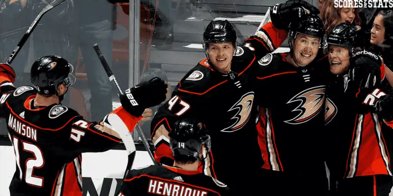 Winnipeg Jets vs Anaheim Ducks Picks and Predictions January 2nd 2025 2 Anaheim Ducks players wearing black jerseys celebrate together on the ice after scoring a goal, showing excitement and team unity during an NHL hockey game.