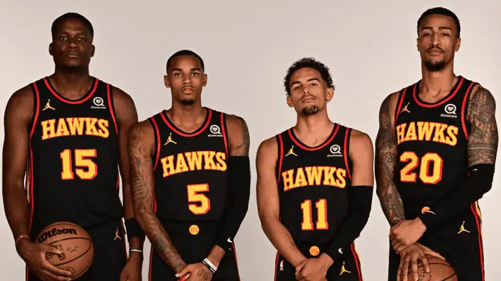 Atlanta Hawks vs Phoenix-suns Picks and Predictions January 14th 2025 2 Four Atlanta Hawks basketball players in black jerseys posing for a team photo