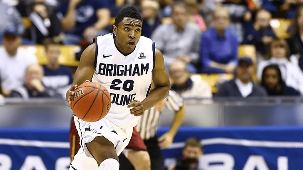 Colorado Buffaloes vs Byu Cougars Picks and Predictions January 21st 2025 2 A basketball player from Brigham Young University dribbles the ball during a game, with a focused expression and supporters