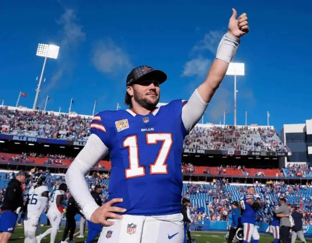 Kansas City Chiefs vs Buffalo Bills Picks and Predictions January 26th 2025 2 A football player in a blue jersey with "Bills" and the number 17 raises one hand in celebration, with a cheering crowd in the background.