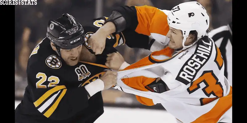 Vegas Golden Knights vs Philadelphia Flyers Picks and Predictions January 2nd 2025 2 Boston Bruins player in a black jersey grappling with Philadelphia Flyers player Jay Rosehill in a white and orange jersey during an intense NHL on-ice fight.