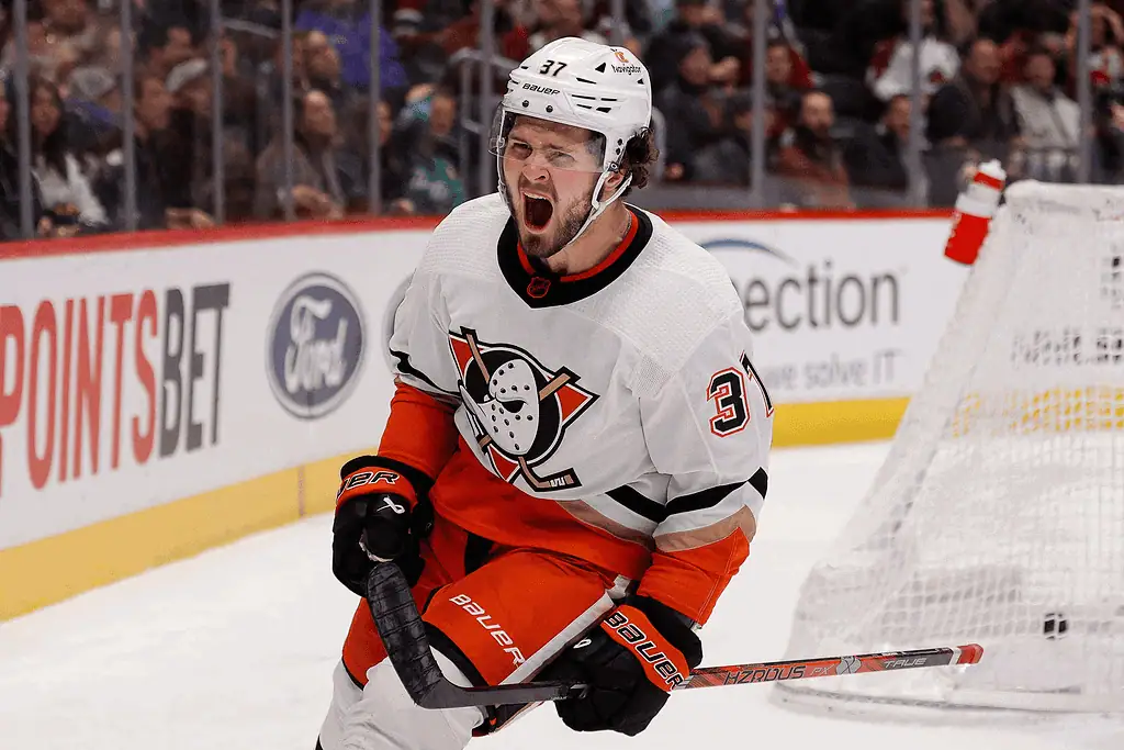 Seattle Kraken vs Anaheim Ducks Picks and Predictions January 28th 2025 2 A hockey player in an orange and white uniform celebrates on the ice, holding a stick, with fans visible in the background.
