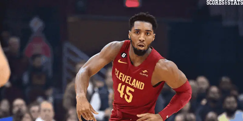 Dallas Mavericks vs Cleveland-cavaliers Picks and Predictions January 3rd 2025 2 Cleveland Cavaliers guard Donovan Mitchell wearing a red jersey with number 45, driving forward during an NBA game with focused intensity.