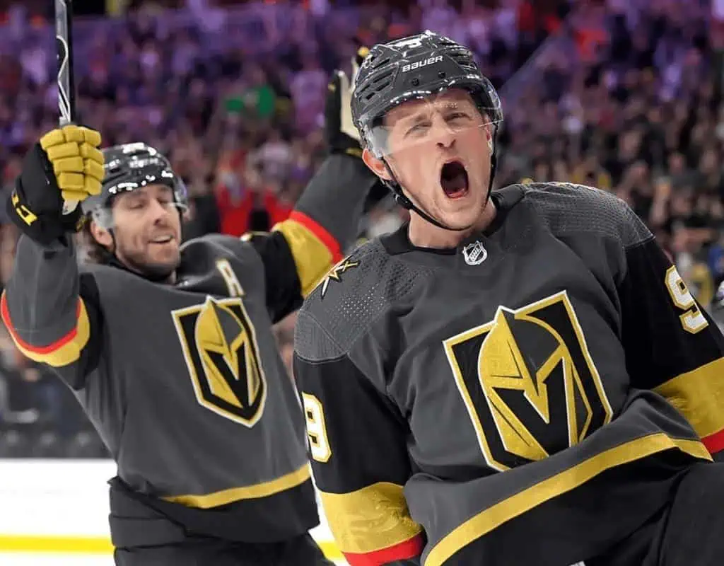 Vegas Golden Knights vs Columbus Blue Jackets Picks and Predictions January 30th 2025 2 Two hockey players in black Vegas Golden Knights jerseys celebrate a goal, one raising his stick high in excitement.