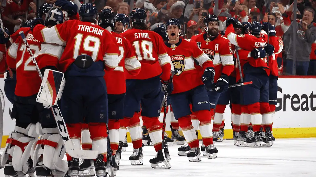 Philadelphia Flyers vs Florida Panthers Picks and Predictions January 13th 2025 2 Three Toronto Raptors players in black jerseys discuss strategy with a coach holding a clipboard during a basketball game.