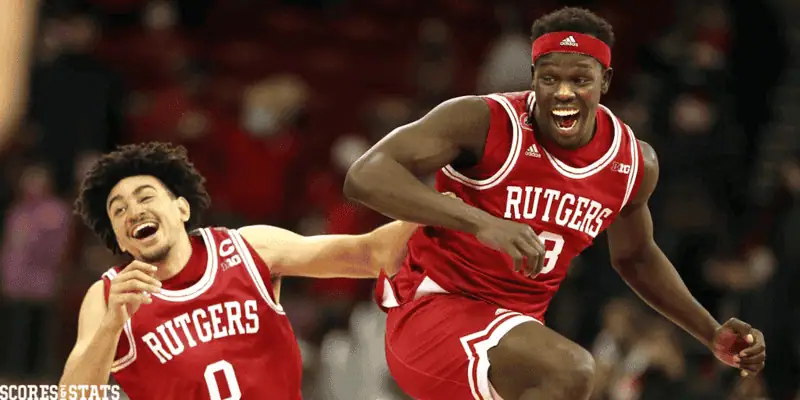 Rutgers Scarlet Knights vs Wisconsin Badgers Picks and Predictions January 6th 2025 2 Two Rutgers basketball players celebrate joyfully on the court after a Big Ten win, wearing red jerseys with big smiles.