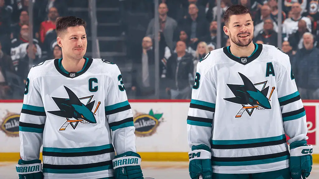 Seattle Kraken vs San Jose Sharks Picks and Predictions January 30th 2025 2 Two hockey players in Sharks uniforms stand side by side on the ice, one wearing a captain’s C and the other an A.