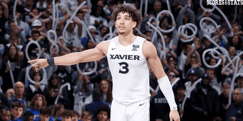 Georgetown Hoyas vs Xavier Musketeers Picks and Predictions January 3rd 2025 2 Xavier basketball player pointing during intense college game