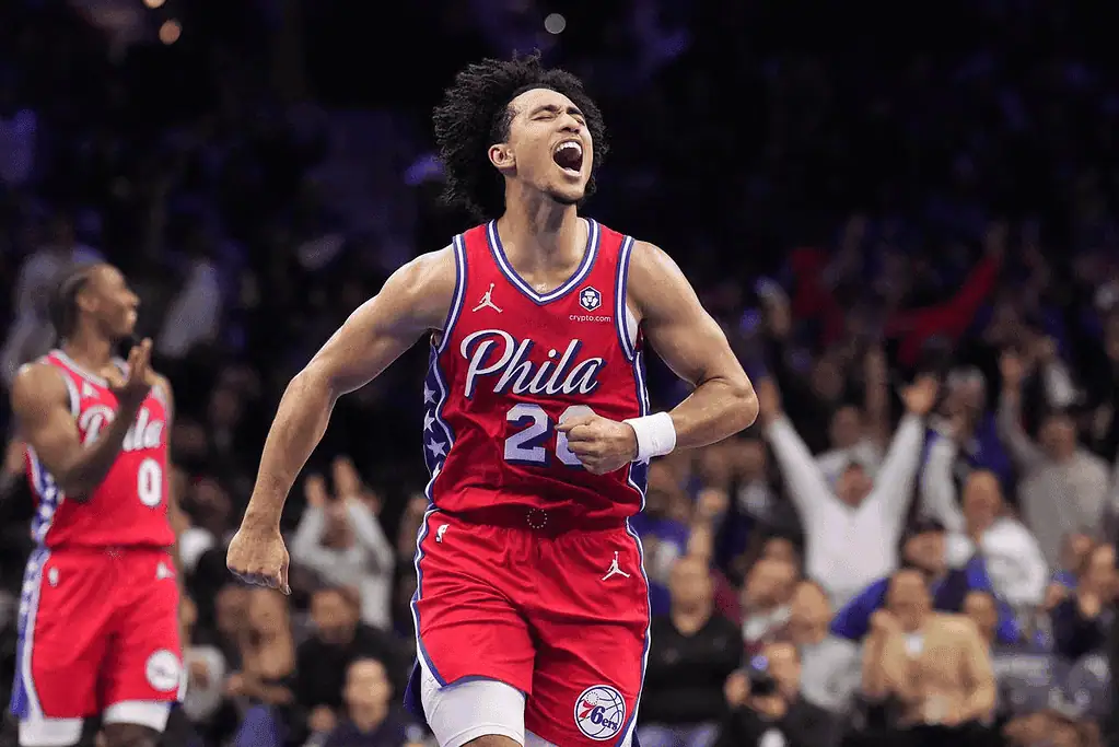 Orlando Magic vs Philadelphia-76ers Picks and Predictions January 12th 2025 2 A basketball player in a red Philadelphia 76ers jersey celebrates on the court with enthusiastic fans in the background.