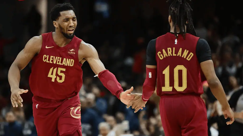 Cleveland-cavaliers vs New York Knicks Picks and Predictions February 21st 2025 3 Two Cleveland Cavaliers players, one wearing jersey number 45 and the other 10, share a high-five during a game.
