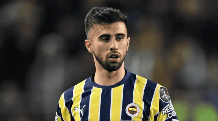 Fenerbahçe soccer player in a yellow and navy striped jersey, looking focused during a match