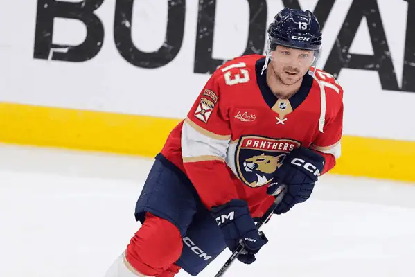 Washington Capitals vs Florida Panthers Picks and Predictions February 4th 2025 2 Florida Panthers player wearing a red jersey and number 13 skates during a game, focused on the play ahead.
