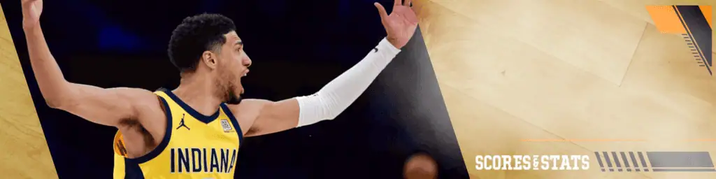 Washington-wizards vs Indiana Pacers Picks and Predictions February 12th 2025 2 Indiana Pacers basketball player wearing a yellow jersey with arms raised, showing an intense reaction during an NBA game.