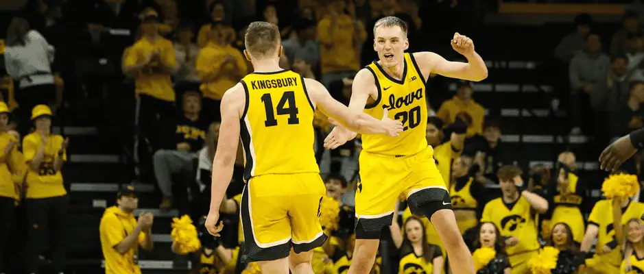 Northwestern Wildcats vs Iowa Hawkeyes Picks and Predictions February 28th 2025 2 Two Iowa Hawkeyes basketball players, including one wearing jersey number 14 (Kingsbury), celebrate with a high-five during a game