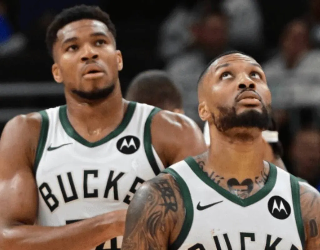 Washington-wizards vs Milwaukee Bucks Picks and Predictions February 21st 2025 2 Two basketball players wearing Milwaukee Bucks jerseys stand together on the court, displaying intense focus during a game.